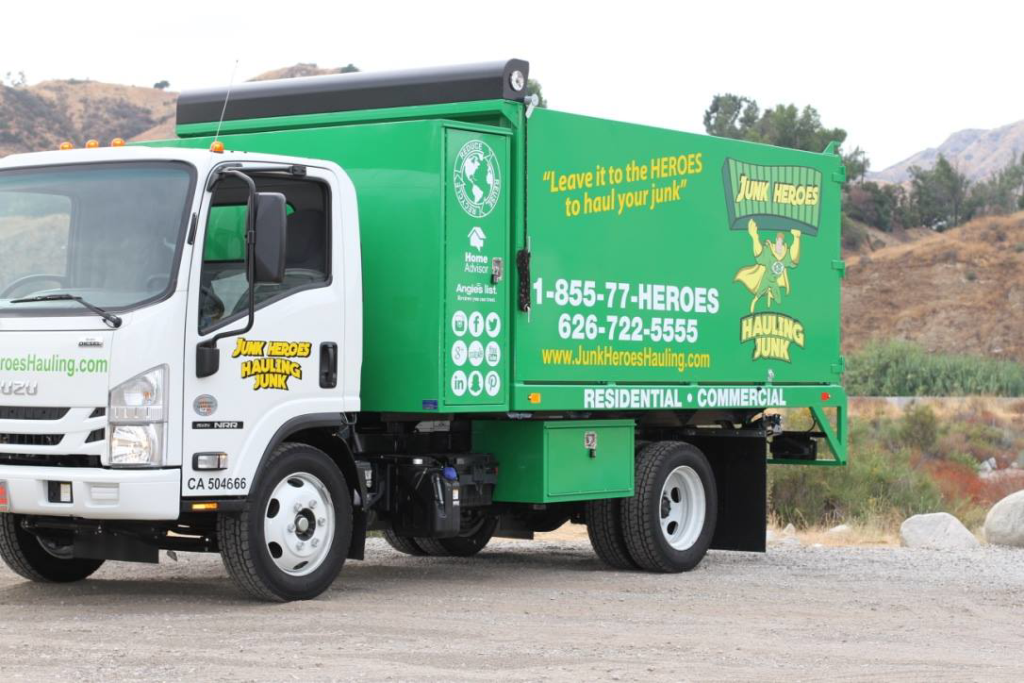 A green and white Junk Heroes Hauling Junk truck ready for commercial junk hauling service in Pasadena, CA.