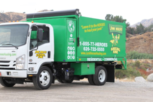 A green and white Junk Heroes Hauling Junk truck ready for commercial junk hauling service in Pasadena, CA.