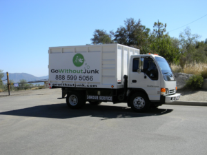 A white junk removal truck from GO WITHOUT JUNK, ready for service in Burbank, CA.