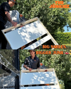 A Junkiez Junk Removal team member loading a large piece of furniture into a truck in Los Angeles, CA.