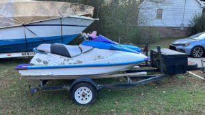 An old, worn jet ski on a trailer, ready for removal by Federal Junk Removal in Los Angeles, CA.
