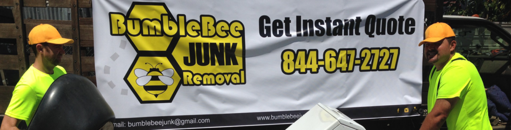 Two workers removing a black item and a white appliance for BumbleBee Junk in Sun Valley, CA.