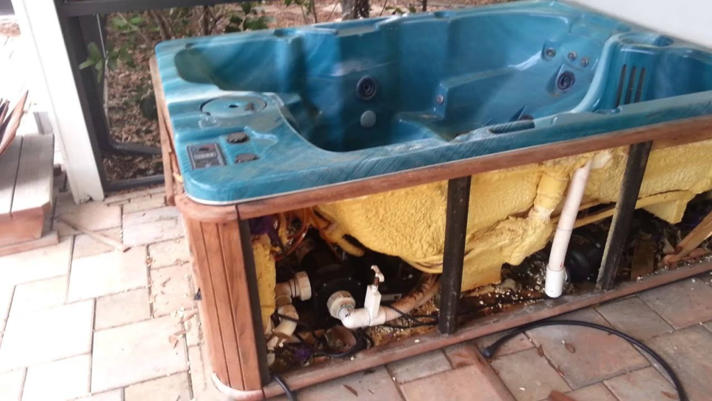 A broken hot tub on a patio, disassembled and ready for removal by Harvey's Junk Hauling and Recycling LLC in Scottsdale, AZ.