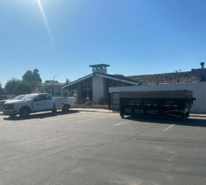 A commercial roll-off dumpster from Bakersfield Roll-Off Service placed in a parking lot in Bakersfield, CA.