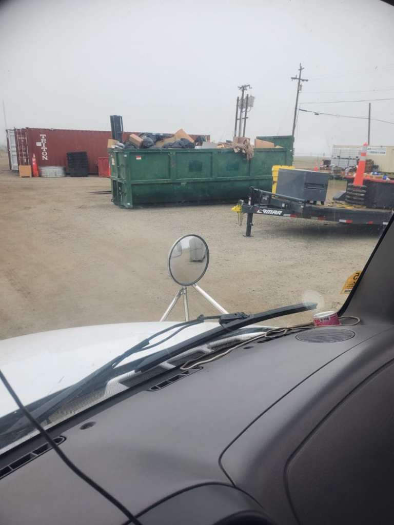 A West Coast Recycle dumpster filled with various junk and debris from a removal job in San Jose, CA.