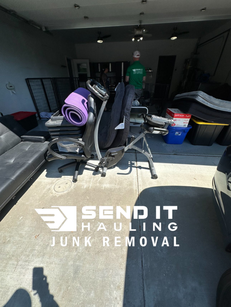A garage filled with large items like a sofa and exercise equipment, ready for junk removal by Send It Hauling & Junk Removal LLC in Manteca, CA