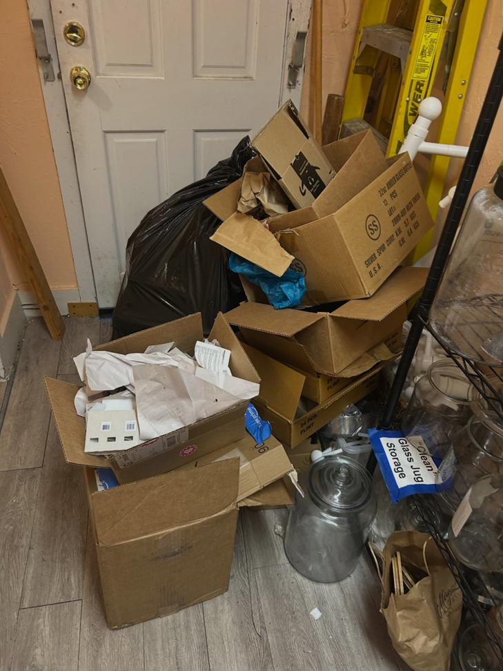 A pile of cardboard boxes and trash bags awaiting removal by Ditch it in Martinez, CA.