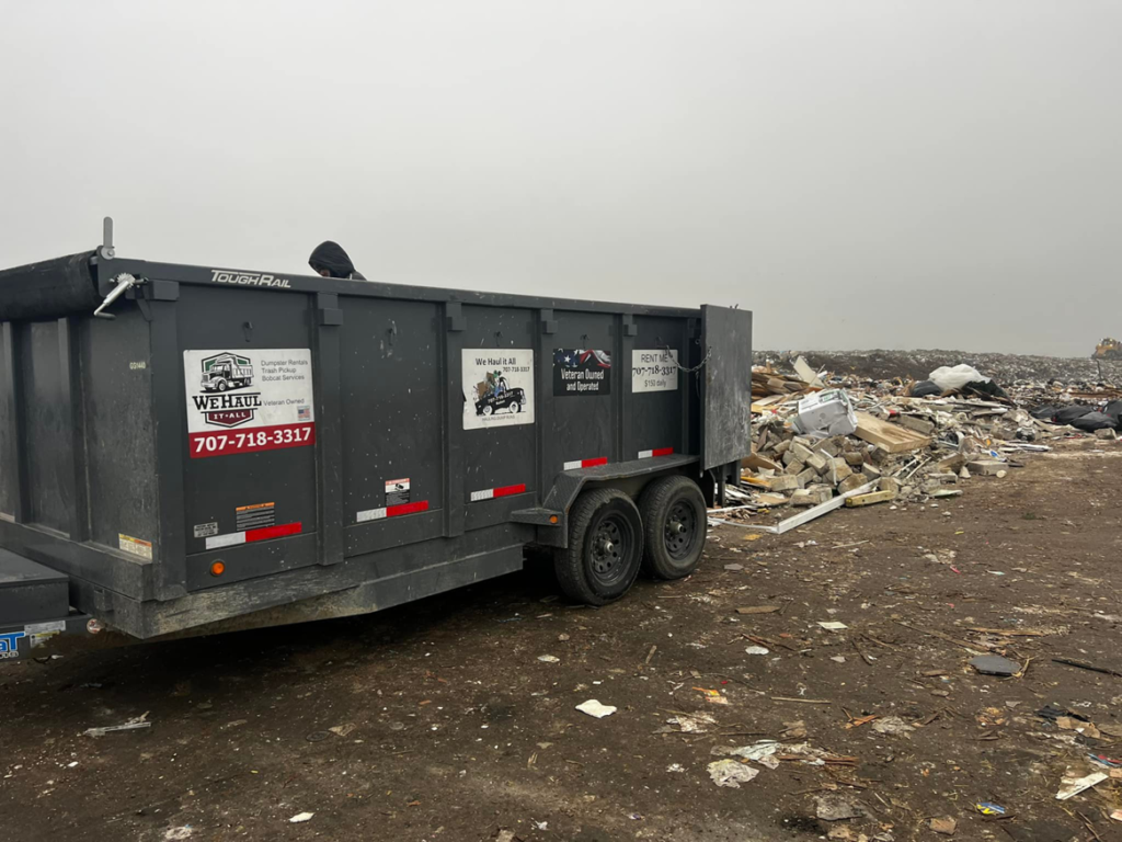 A We Haul It All junk removal trailer parked at a landfill or transfer station after a job in Lakeland, FL