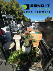 A junk removal truck filled with various household items and debris for hauling by Send It Hauling & Junk Removal LLC in Manteca, CA