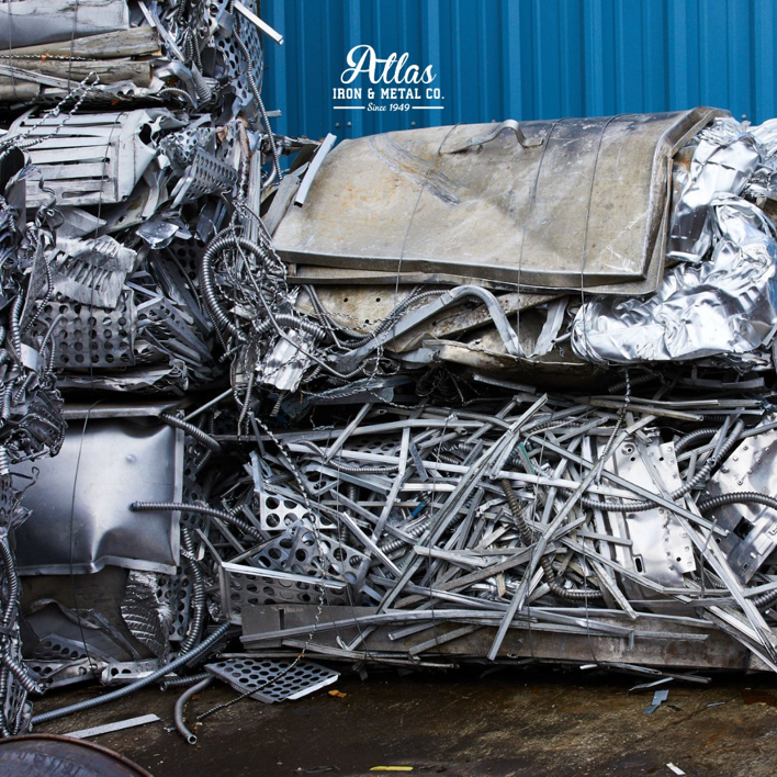 A large pile of various scrap metals, including shredded and baled pieces, at Atlas Iron & Metal Co. in Los Angeles, CA