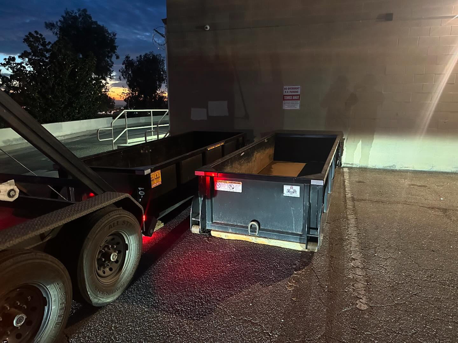 Two roll-off dumpsters delivered by Bakersfield Roll-Off Service for a project at night in Bakersfield, CA.