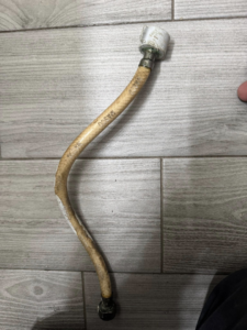 An old, worn water supply line removed during a plumbing repair by Peraza Handyman Services Llc in Bakersfield, CA.