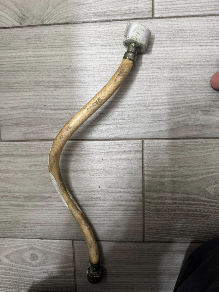 An old, worn water supply line removed during a plumbing repair by Peraza Handyman Services Llc in Bakersfield, CA.