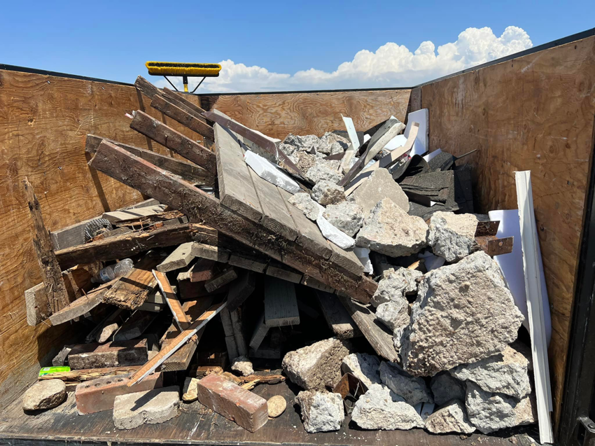 A trailer filled with mixed construction debris for removal by SD Junk Takers Hauling and Junk Removal in San Diego, CA.