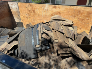 A trailer filled with old roofing shingles for removal by SD Junk Takers Hauling and Junk Removal in San Diego, CA.