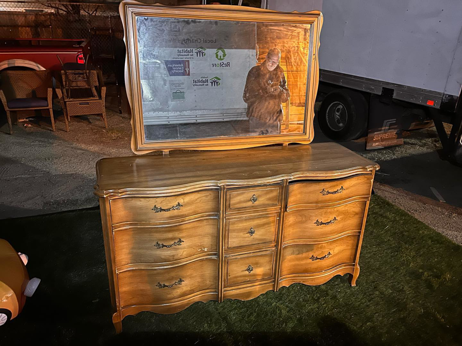 A large wooden dresser and mirror placed outdoors for general junk removal by Junk2Dump in Sacramento, CA.