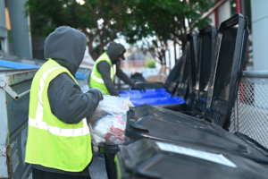 Workers from Bay Area Bin Support emptying and sorting items into bins for general junk removal in San Leandro, CA.